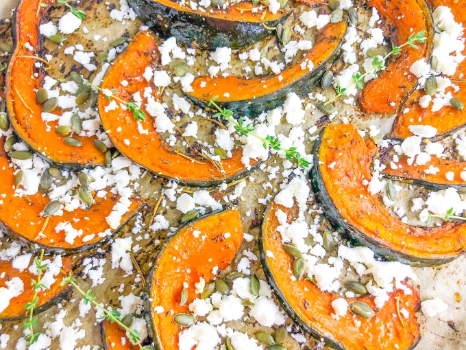 Detailed image of roast pumpkin wedges with feta and thyme leaves